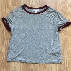 Grey and maroon cropped t shirt.